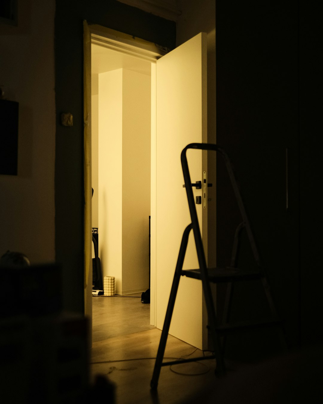 services-03 open-door-with-a-stepladder-in-a-dimly-lit-room-4vxb1aqfbk0