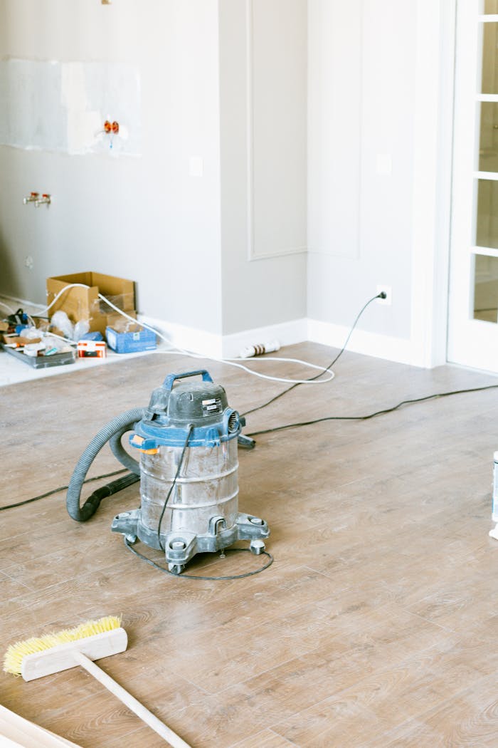 services-04 Vacuum and tools in a room undergoing renovation, showcasing home improvement.